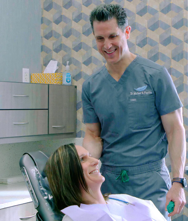A female patient smiling up at a staff member before discussing cosmetic dentistry options in OH at Fioriotto Family Dental.